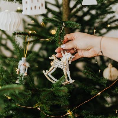 https://www.pexels.com/photo/person-holding-rocking-horse-christmas-ornament-6032713/